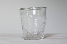 Load image into Gallery viewer, Clear textured glass tumbler on a wooden surface with a plain background
